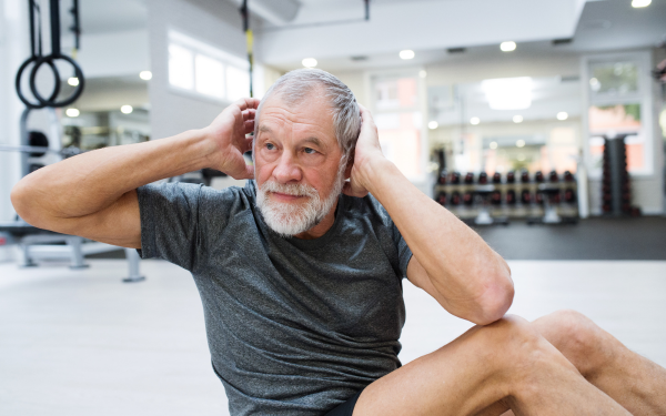 Senior man performing crunches to improve core strength