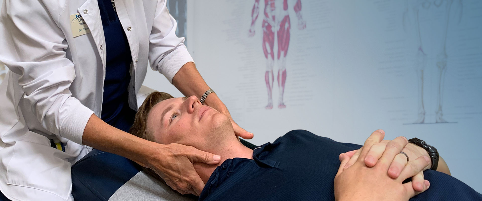 Dr. Vivian Ebert adjusting patients neck